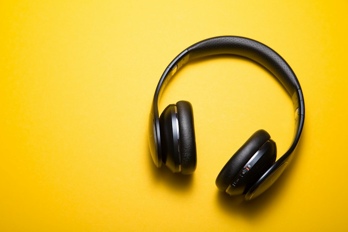 Headphones on a warm yellow background